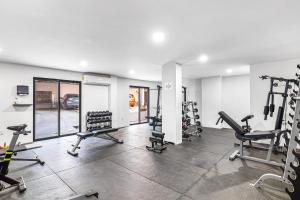 a gym with several treadmills and tread machines at Morgan Residences 607 in Cabo San Lucas