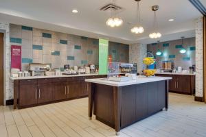 a large kitchen with a counter in a restaurant at Hampton Inn and Suites Rome, GA in Rome