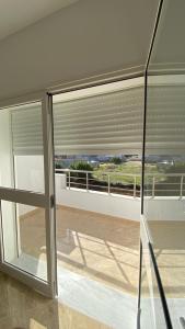 a room with a window with blinds on a balcony at Deluxe apartment in Kelibia