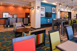 a lobby with tables and chairs and a bar at Hampton Inn Pittsburgh - Wexford - Cranberry South in Wexford