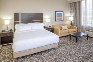 a hotel room with a bed and a chair at DoubleTree by Hilton Boston-Rockland in Rockland