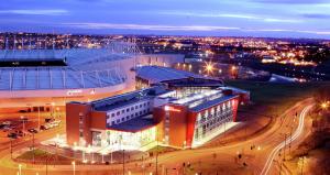 a large building with lights on in a city at night at Hilton Garden Inn Sunderland in Sunderland