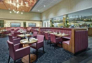 a restaurant with tables and chairs and a bar at Hilton Garden Inn Sunderland in Sunderland