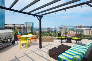 a patio with chairs and tables on a balcony at Home2 Suites by Hilton Atlanta Downtown in Atlanta