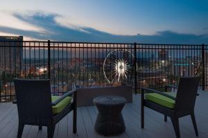 a balcony with two chairs and a table and a wheel at Home2 Suites by Hilton Atlanta Downtown in Atlanta