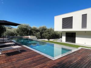 a swimming pool in the backyard of a house at Olivo Luxury Apartments in Malcesine