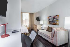 a hotel room with a couch and a bed at Home2 Suites by Hilton Atlanta Downtown in Atlanta
