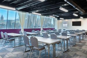 une salle de conférence avec des tables, des chaises et des fenêtres dans l'établissement Home2 Suites by Hilton Atlanta Downtown, à Atlanta