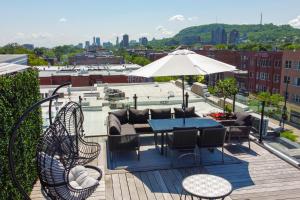 a patio with a table and chairs and an umbrella at Parc Avenue Hostel in Montreal