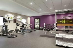a gym with several treadmills and elliptical machines at Home2 Suites by Hilton West Monroe in West Monroe