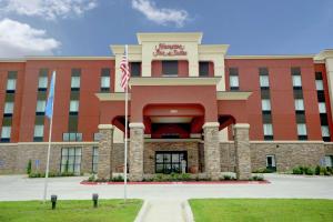 a building with an american flag in front of it at Hampton Inn & Suites Ponca City in Ponca City
