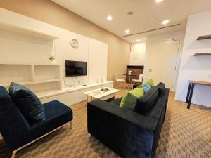 a living room with two couches and a flat screen tv at Bukit Bintang KLCC Binjai 8 Premium Soho Apartment by Sarah's Lodge in Kuala Lumpur