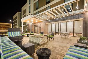 a patio with chairs and tables and a building at Home2 Suites By Hilton Oklahoma City Yukon in Yukon