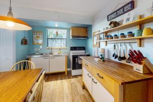 a kitchen with blue walls and a wooden counter top at Angler's Dream in Marco Island +27 photos