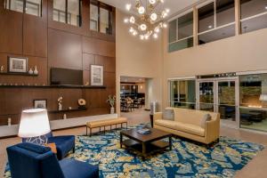 a living room with blue furniture and a chandelier at Hampton Inn & Suites Los Angeles - Glendale in Glendale