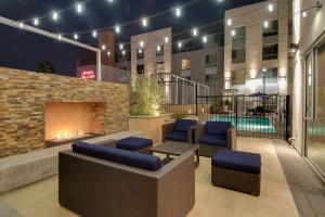 a hotel patio with a fireplace and a pool at Hampton Inn & Suites Los Angeles - Glendale in Glendale