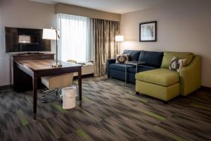 a living room with a couch and a desk in a hotel room at Hampton Inn & Suites By Hilton Hammond, In in Hammond