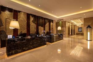 a lobby of a hotel with a large wall at Hilton Wuhan Yangtze Riverside in Wuhan