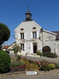 a white building with a clock tower on top of it at les galipes in Hautvillers