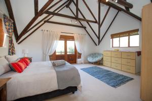 a bedroom with a large bed and a dresser at 152 Village House in St Francis Bay