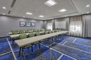 a conference room with a long table and green chairs at Hampton Inn & Suites Guthrie, OK in Guthrie