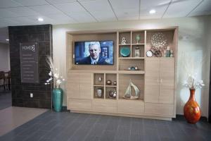 a flat screen tv on a wall in a store at Home2 Suites by Hilton Tulsa Hills in Tulsa