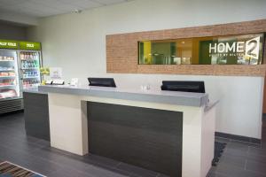 a lobby with a counter in a store at Home2 Suites by Hilton Tulsa Hills in Tulsa