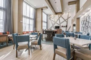 a lobby with tables and chairs and a pool table at Hampton Inn & Suites Dallas-Central Expy/North Park Area in Dallas