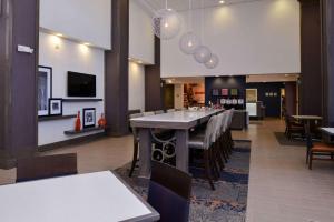 a dining room with a long table and chairs at Hampton Inn & Suites Albany-East Greenbush, NY in East Greenbush