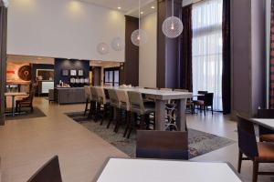 a dining room with a table and chairs at Hampton Inn & Suites Albany-East Greenbush, NY in East Greenbush