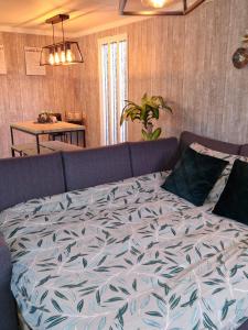 a bed in a living room with a couch at Chalet in Putten in Putten