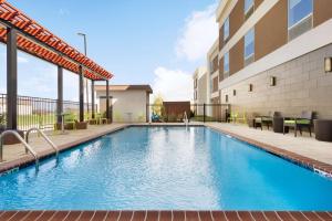 a swimming pool in front of a building at Home2 Suites By Hilton Baton Rouge in Baton Rouge