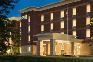 an office building with a flag in front of it at Home2 Suites By Hilton Middleburg Heights Cleveland in Middleburg Heights