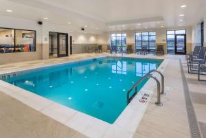 a large swimming pool with blue water in a building at Hampton Inn & Suites Newport/Cincinnati, KY in Newport