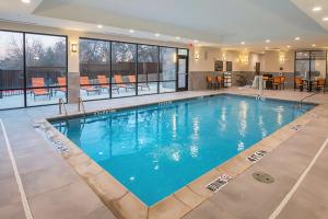 a large swimming pool with blue water in a building at Hampton Inn & Suites Colleyville DFW Airport West in Colleyville