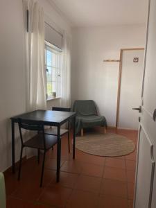 a dining room with a table and a chair at Guesthouse Releash Aljezur in Aljezur