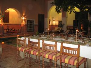 a group of chairs sitting around a table with candles at Riad Barroko in Marrakesh