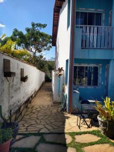 a pathway leading to a blue and white building at Águas de Carrancas FLATS in Carrancas