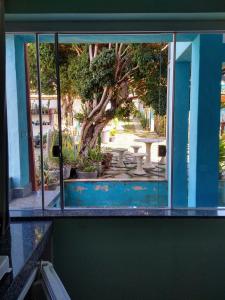 a window of a building with a view of a patio at Águas de Carrancas FLATS in Carrancas