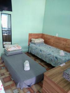 two twin beds in a room with at Águas de Carrancas FLATS in Carrancas +42 photos