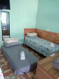 two twin beds in a room with at Águas de Carrancas FLATS in Carrancas