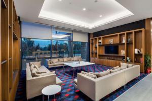 a living room with couches and a table in a room at Hampton By Hilton Izmir Aliaga in Aliağa