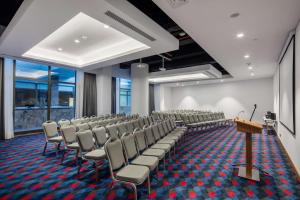 a conference room with chairs and a podium at Hampton By Hilton Izmir Aliaga in Aliağa