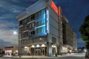 a hotel building with a neon sign on it at Hampton Inn & Suites Los Angeles/Hollywood, CA in Los Angeles
