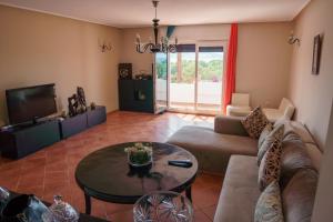 a living room with a couch and a table at Sea view malabata family only in Tangier