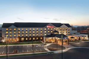 a hotel building with a parking lot in front of it at Hilton Garden Inn Medford in Medford