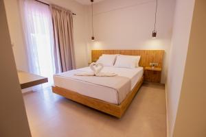 a bedroom with a bed with a towel on it at Haus Riviera in Asprovalta