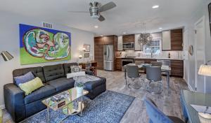 a living room with a couch and a kitchen at The Home Collection CLT: 510 Queens in Charlotte