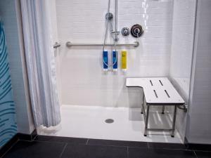 a bathroom with a shower with a sink and a tub at Tru By Hilton Oklahoma City Airport, Ok in Oklahoma City