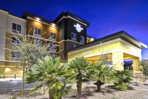 a building with palm trees in front of it at Homewood Suites By Hilton Phoenix Tempe Asu Area in Tempe